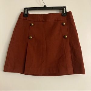 Copper, pleated mini skirt with gold buttons. Express size 6.